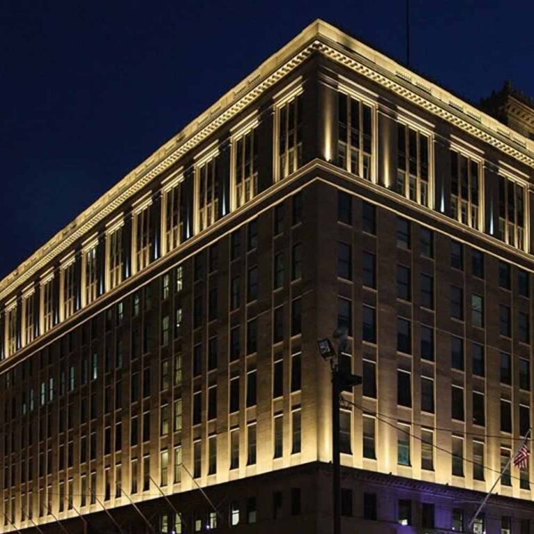 Denver hotel building exterior illuminated at night with modern, automated smart lighting solutions.