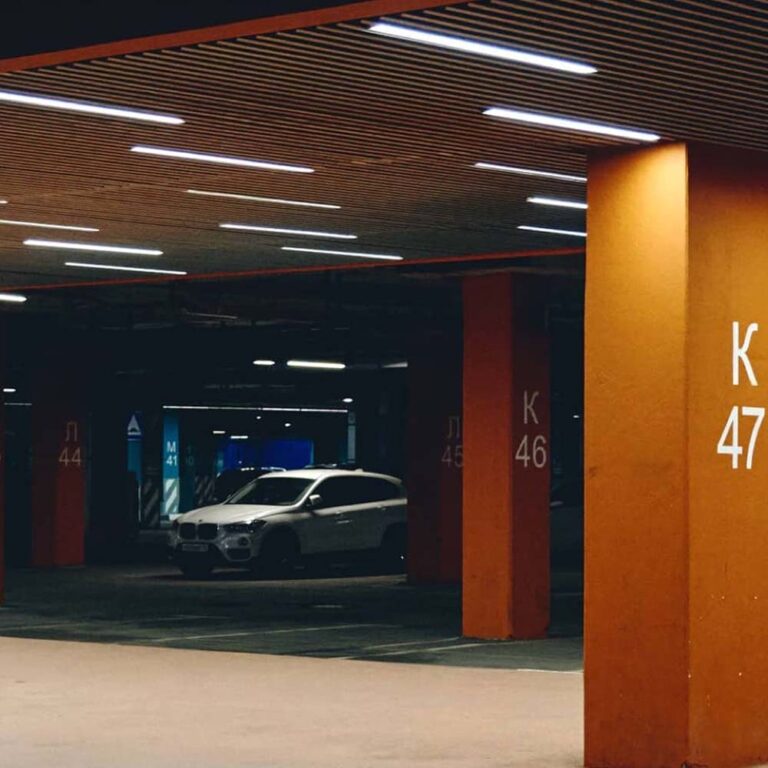Well-lit modern parking garage with smart linear LED lighting, showcasing efficient and safe illumination.